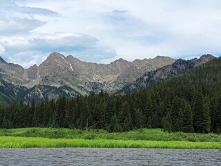 piney lake and the gore range in summer, near vail,  in the rocky mountains of colorado  
