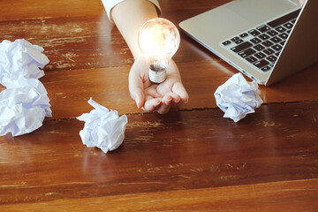 Idea of business person holding light bulb concept creativity with bulbs. © Charlie's