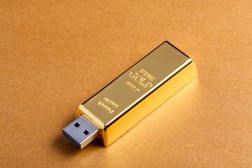 Removable gold bar USB drive on yellow background. Financial&IT concept.