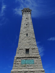 pilgrims' monument next to cape cod bay on a sunny spring day  in provincetown, massachusetts