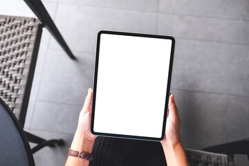 Top view mockup image of a woman holding digital tablet with blank white desktop screen
