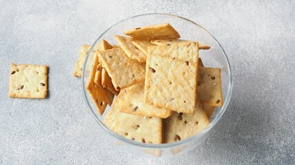Delicious healthy cookies crackers with flax seeds and sesame seeds women hands are placed on a plate. Background of a healthy snack food, close up. - Powered by Adobe