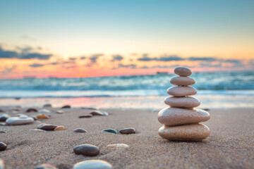 Stones balance on the beach and color sunrise. Zen meditation and relaxation