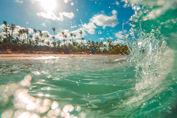 Sea wave, blue sky with clouds, palm trees and beach. Punta Cana, Dominican Republic - obrazy, fototapety, plakaty