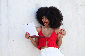 beautiful afro-american woman in a video conference with laptop. The woman is having fun while explaining what they are talking about. Telework concept. Video call