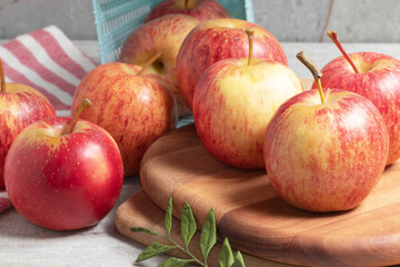 Ripe red apples on wooden table.