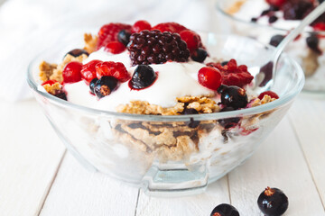 Granola with yogurt, strawberries, blackberries and blueberries