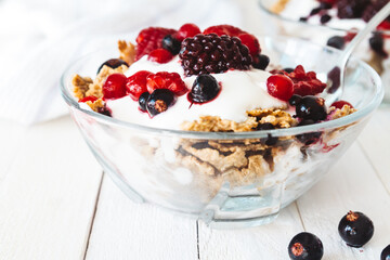 Granola with yogurt, strawberries, blackberries and blueberries