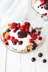 Granola with yogurt, strawberries, blackberries and blueberries