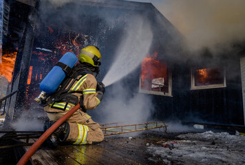 Firefighters trying to put out flames cabin on fire