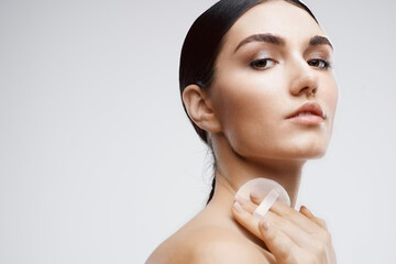 woman with bare shoulders skin care cream rejuvenation