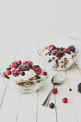 Granola with yogurt, strawberries, blackberries and blueberries. Vintage Instagram style effect