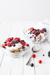 Granola with yogurt, strawberries, blackberries and blueberries