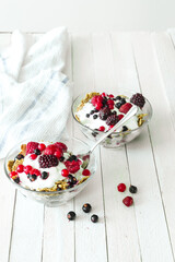 Granola with yogurt, strawberries, blackberries and blueberries