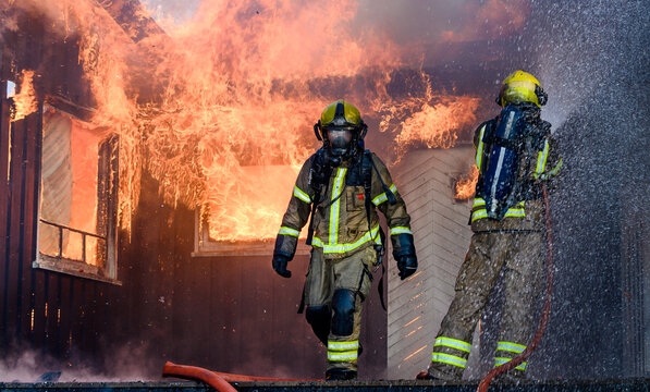 Firefighters trying to put out flames cabin on fire