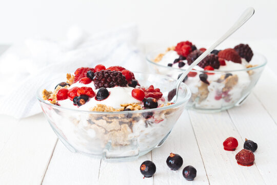 Granola with yogurt, strawberries, blackberries and blueberries