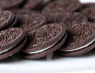 Brown cookies with white cake filling. Close-up