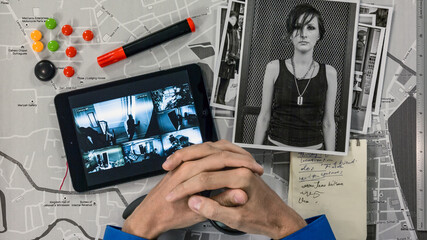 Detective to look at the tablet photos of criminals who recorded a hidden camera