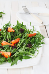 Fresh salad with rucola and  blackberry, close up..