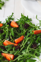 Fresh salad with rucola and  blackberry, close up..