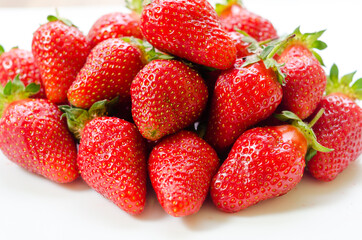 Fresh and natural garden strawberries on a white plat