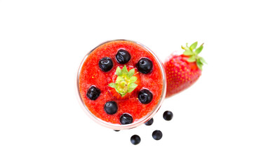 Fresh berries fruit and smoothies in tall glass on white . Blueberries and strawberries. Top View