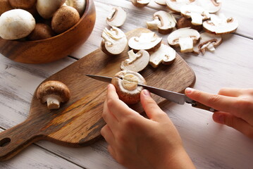 Cooking mushrooms by the cook, mushrooms on the background of a wooden board