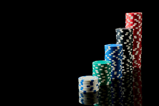 Stack of Casino gambling chips isolated on black reflective background