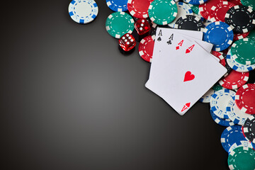 Casino chips, playing cards and dices on dark reflective background