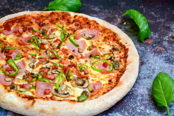  Close up of    hot italian pizza   classic ham. Fresh basil,tomato sauce ,mozzarella cheese , mushrooms and  minced meat .Concept poster for Restaurants or pizzerias. Top view