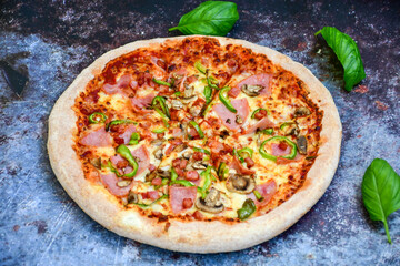  Close up of    hot italian pizza   classic ham. Fresh basil,tomato sauce ,mozzarella cheese , mushrooms and  minced meat .Concept poster for Restaurants or pizzerias. Top view