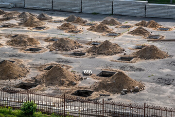 rows of pits at a construction site. preparation of the site for the installation of piles. a pile...