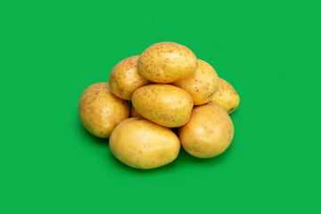 Fresh potatoes on green background