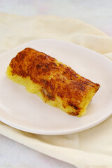 cheese dessert on a white wooden background. Local name peynir tatlisi