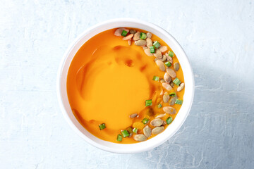 Pumpkin soup with seeds and scallions. Vegan butternut squash cream soup, healthy dinner, overhead shot