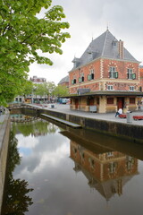Reflections of de Waag, historic public weigh house (dated from 1598), located on Waagplein square in Leeuwarden, Friesland, Netherlands