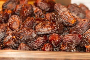 Phoenix dactylifera, date in bulk ready for sale in glass container, selective focus.