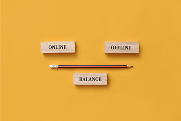 Wooden plate in the form of scales with inscriptions: online and offline. A symbol of the balance between online and offline in life