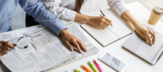 Young unemployed is searching for a job in the newspaper and laptop. Interview the job and hiring...