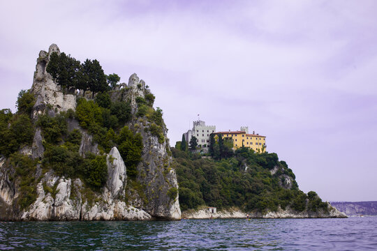 Duino, Italy. June 20, 2021 seen from the sea the two castles of Duino, the first only remains the second in the background