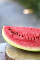 Slice of watermelon, served in a garden. Selective focus.