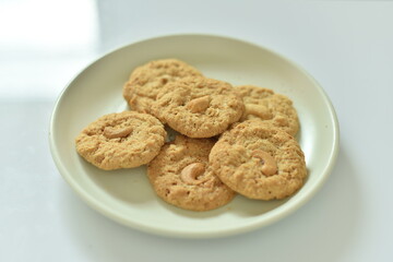 Bread Biscuits with Cashew Nuts on dish on white background..