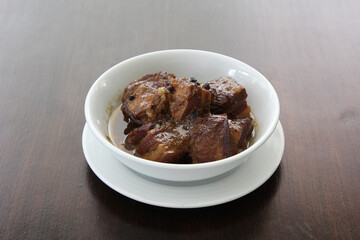Chinese pork belly caramelized and braised in soy sauce with star anise, cinnamon and chilies.