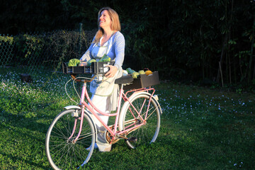 Fototapeta premium woman with bycicle with green healthy vegetables food