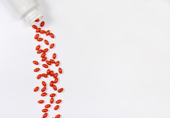 Orange capsules of lutein on a white background with place for text. Supplements and herbal medicine, homeopathy, treatment and prevention