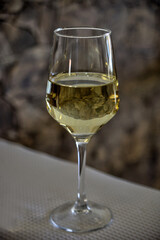 Alentejo white wine glass with stone background.