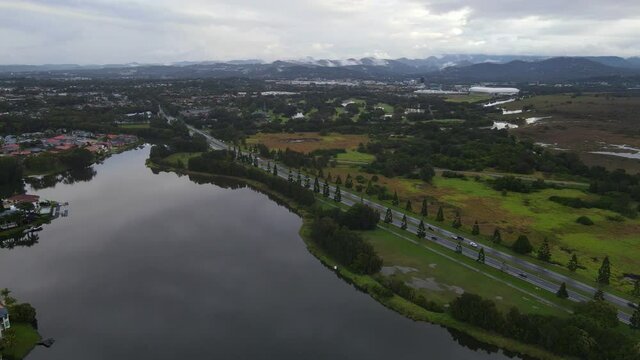 Coastal Road Of Robina Parkway Near The Calm Lake At Clear Island Waters Suburb In Gold Coast, Queensland, Australia. aerial