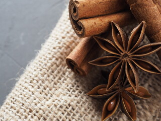 Star anise and cinnamon on a gray background under concrete