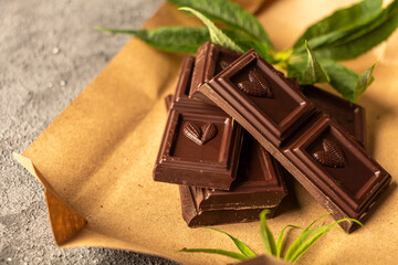 Vegan dark  chocolate with cannabis leaves. Desert with CBD butter. Medicinal marijuana in food, vegan, supplements consept