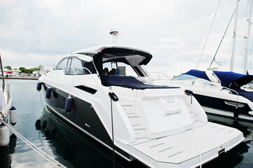 Fototapeta na wymiar Marine parking of modern motor boats. Luxury yachts docked in sea port.